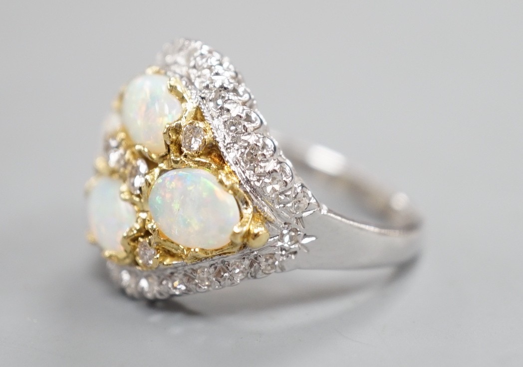 A modern 18ct white gold, diamond and four stone oval white opal set cluster dress ring, size N, gross weight 6.9 grams.